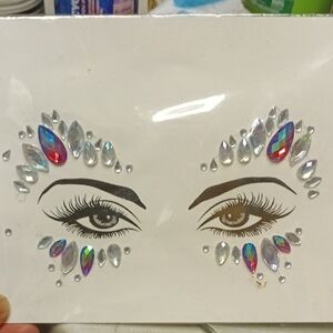 Silver Brow Makeup with Dramatic Eyeliner and Sparkling Embellishments